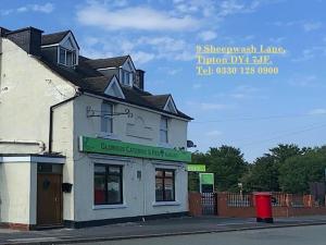 a building on the corner of a street at Glorious catering & Restaurant BnB in Ocker Hill