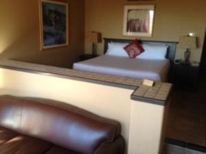 a hotel room with a bed and a couch at Gold Canyon Golf Resort in Gold Canyon
