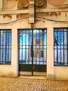 a door to a building with wrought iron gates at Rainbow Guest House in Lisbon