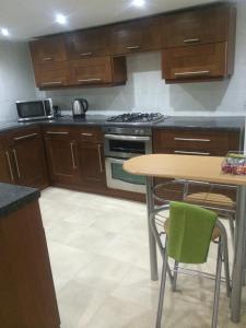 a kitchen with a table and a stove top oven at Admiral Hotel in Scarborough