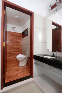 a bathroom with a toilet and a sink at Hotel Tierra Linda in San Ignacio de Velasco
