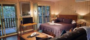 a hotel room with two beds and a television at Treetops Montville in Montville