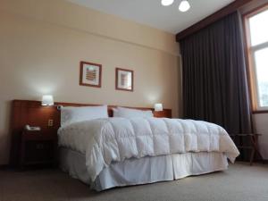 Postel nebo postele na pokoji v ubytování Gran Hotel Isabel Riquelme
