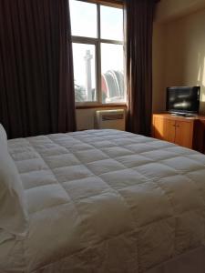 Postel nebo postele na pokoji v ubytování Gran Hotel Isabel Riquelme
