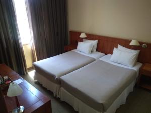 Postel nebo postele na pokoji v ubytování Gran Hotel Isabel Riquelme
