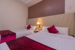 Postel nebo postele na pokoji v ubytování Vy Anh Đà Lạt Hotel