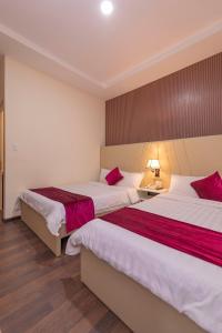Postel nebo postele na pokoji v ubytování Vy Anh Đà Lạt Hotel