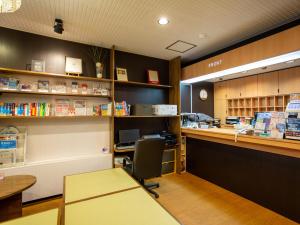 a restaurant with a counter and aacistacistacistacistacist at Kaneyoshi Ryokan in Osaka