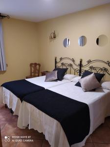 a bedroom with a large black and white bed at Antiguo Casino de los Arribes in Fermoselle