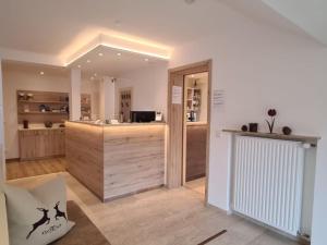 a room with a kitchen with a counter in a room at Hotel Garni Bergidyll - adults only in Pfronten