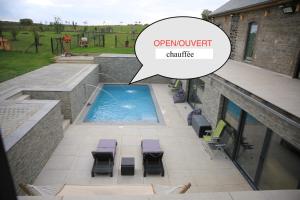 an overhead view of a patio with a swimming pool and a speech bubble saying improvement at Durbuy House in Durbuy