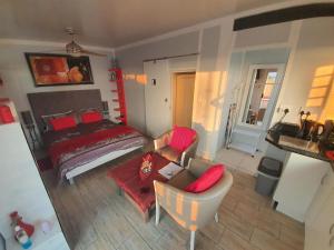 a bedroom with a bed and a couch and a table at Atlantic Studio - Compact unit with Sea Views in Melkbosstrand