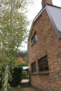 a brick building with a window on the side of it at Yallambee B&B in Bundanoon
