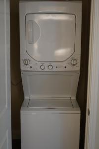 a white microwave sitting on top of a refrigerator at Sleepover 1BD 1BA Oklahoma City Apartments in Oklahoma City