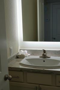 a bathroom counter with a sink and a mirror at Sleepover 1BD 1BA Oklahoma City Apartments in Oklahoma City
