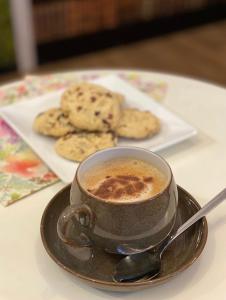 a cup of coffee and cookies on a table at OurStudio in Beverley