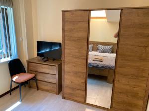 a mirror in a room with a bed and a desk at Sofia Family House - Free Parking in Sofia