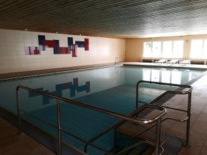 a large swimming pool with at Ferienwohnung Ausblick in Missen-Wilhams