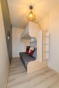 ein kleines Zimmer mit einem Bett in der Mitte einer Treppe in der Unterkunft Vėjūnė in Pervalka