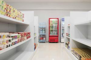 a store aisle with a red refrigerator in the middle at S and M Hotel Inc. in Cebu City