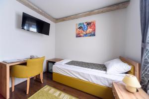 Postel nebo postele na pokoji v ubytování Garni Hotel Mala Moskva