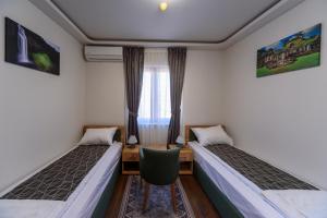 Postel nebo postele na pokoji v ubytování Garni Hotel Mala Moskva