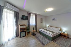 Postel nebo postele na pokoji v ubytování Garni Hotel Mala Moskva