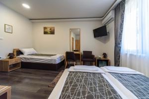 Postel nebo postele na pokoji v ubytování Garni Hotel Mala Moskva