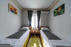Postel nebo postele na pokoji v ubytování Garni Hotel Mala Moskva