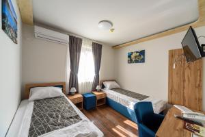 Postel nebo postele na pokoji v ubytování Garni Hotel Mala Moskva