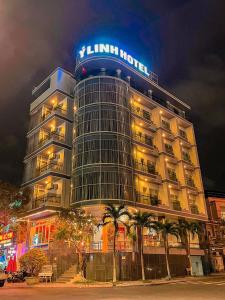 a building with a sign on top of it at night at Y Linh Hotel in Quy Nhon