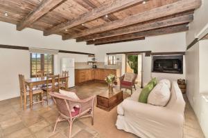 a living room with a couch and a table at Strandveld Vineyards Cottages in Elim +34 photos