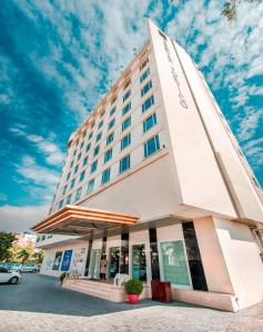 a hotel building with a blue sky in the background at Sarovar Portico Jaipur in Jaipur