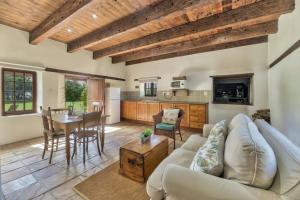 a living room with a couch and a table at Strandveld Vineyards Cottages in Elim