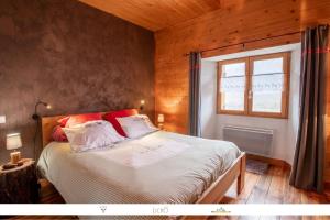 a bedroom with a bed in a room with a window at Chez Mamie Anna (B&B et Chalet) in Bessans