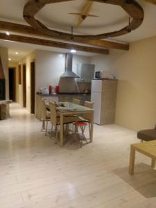 a kitchen with a table and chairs in a room at Apartamento La Agripina in Aldeadávila de la Ribera