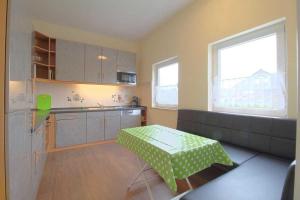 a kitchen with a table in the middle of it at Gaestehaus Dorum 01 in Dorum