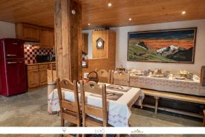 a kitchen with a table and chairs and a refrigerator at Chez Mamie Anna (B&B et Chalet) in Bessans