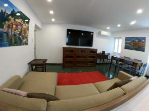a living room with a couch and a flat screen tv at La Casa sul Lago Lecco 2 in Lecco