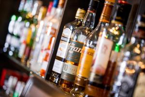 a row of bottles of alcohol on a bar at Howard Arms in Brampton