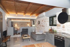 a kitchen and living room with a couch and a table at Xigia Escape villas in Khartáta
