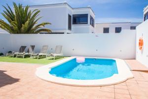 a swimming pool in the backyard of a house at Villa Garoed in Playa Blanca