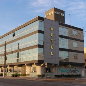 a building with a sign on the side of it at Navega Beach Palace Hotel in Navegantes