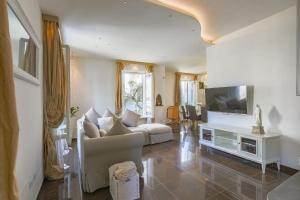 a living room with a couch and a tv at VILLA CORONA 8, Emma Villas in Cattolica