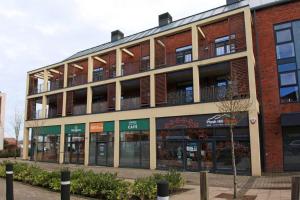 a red brick building with a balcony on top of it at Parkes Court Apartments in Telford