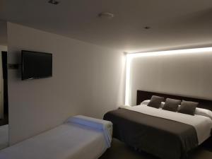 A bed or beds in a room at Hotel Olot Centre