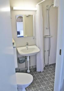 a bathroom with a sink and a toilet and a mirror at Visby Gustavsvik in Visby