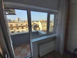 a window in a room with a view of a city at Warm Place In Old Town in Bucharest