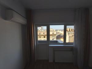 a window in a room with a view of a city at Warm Place In Old Town in Bucharest