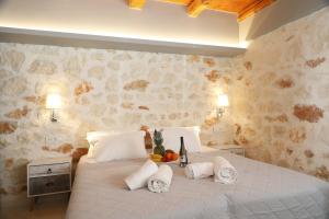 a bedroom with a large white bed with pillows at Xigia Escape villas in Khartáta